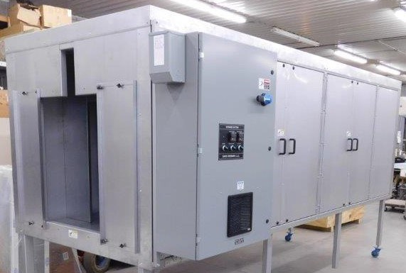 A David Weisman industrial oven with its control panel, on casters in the fabrication shop